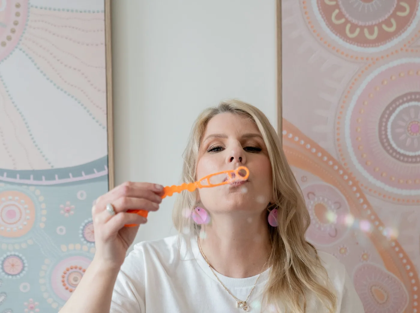 Meg Hughes blowing bubbles in a sensory play room